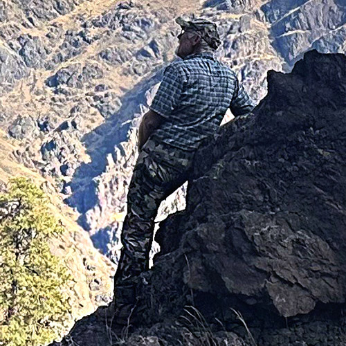Larry Jacobs looking for goats in the mountains